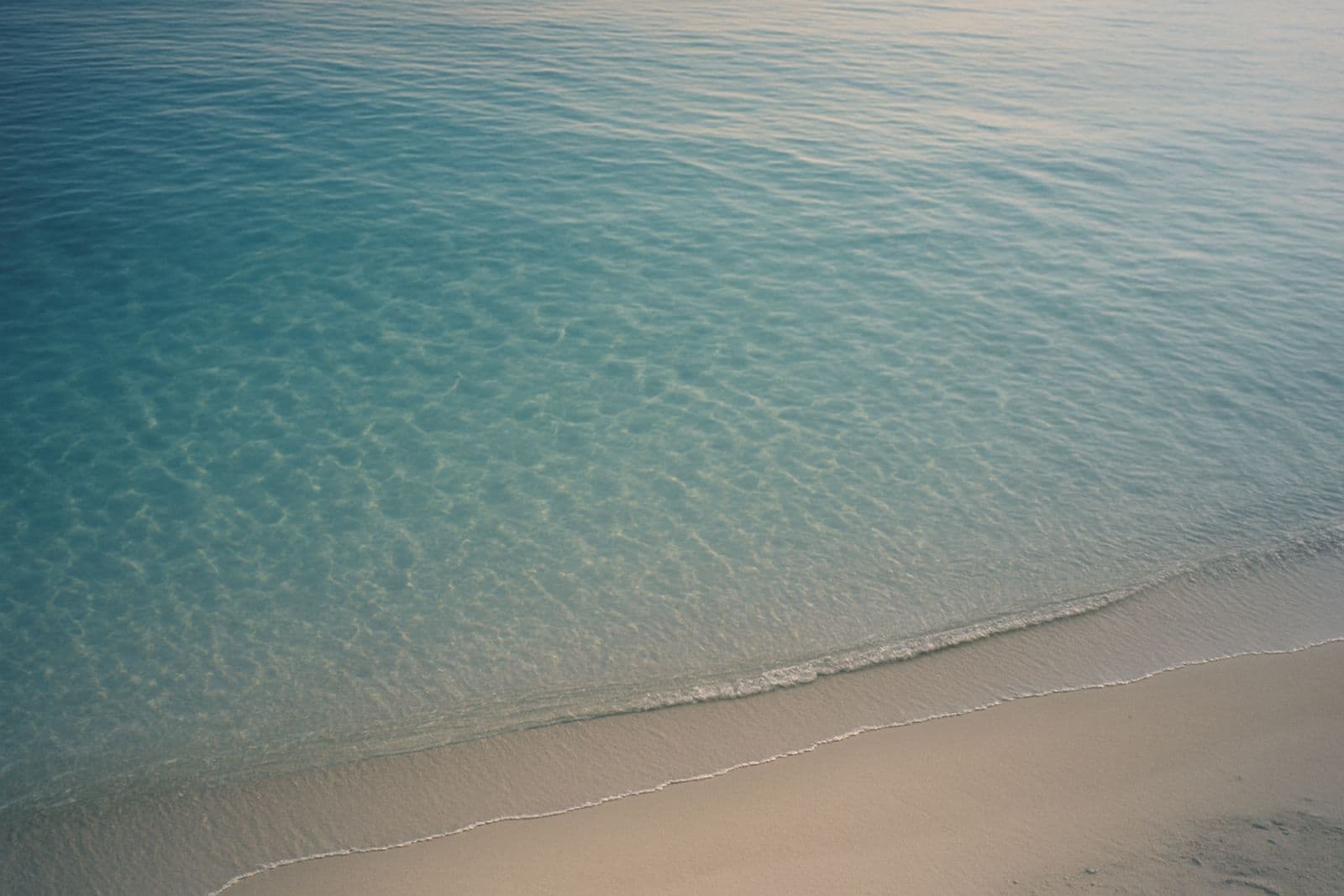 Clear turquoise water over pale sand