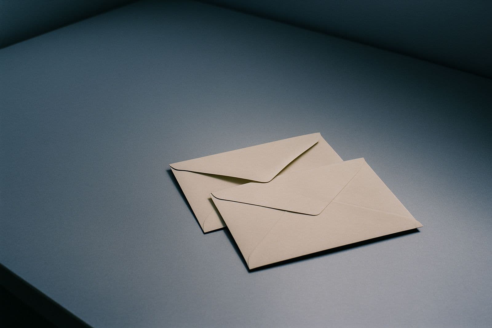 Two plain envelopes side by side on a desk
